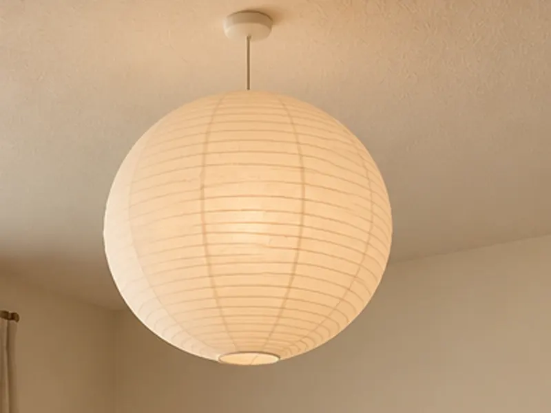 Japandi paper pendant lamp, a large round paper lantern over a living room, AI example design