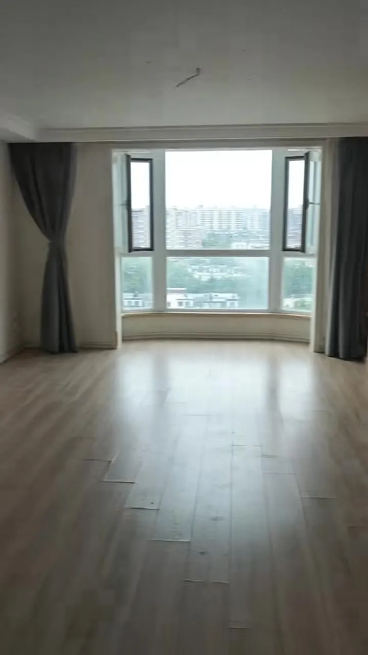 Real phone photo of the second flat's living room facing a big window